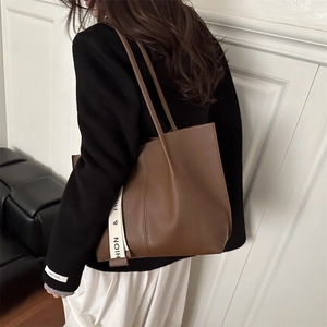Fashionable dark brown leather tote bag with stylish decorative ribbon strap for women