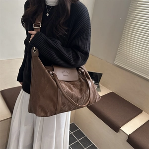 Large capacity brown tote bag with glossy wrinkled fabric shown on a female model