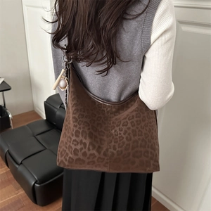 Large leopard print tote bag in brown suede worn by model for casual campus style