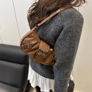 Vintage brown PU leather shoulder bag with decorative silver buckles worn by a model