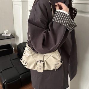 Chic cream white pleated crescent moon bucket bag with silver metal studs and buckle strap