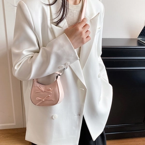 Pink minimalist crossbody bag with sweet bow accents and polished PU leather texture