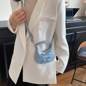 Chic light blue mini square handbag with ribbon bows and detachable strap on model