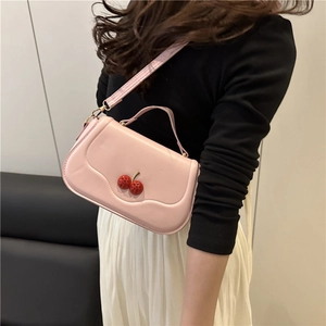 Pink glossy faux leather crossbody bag with cute cherry charm and golden metal hardware