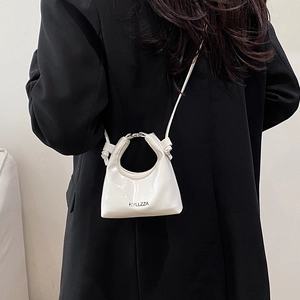 Minimalist white patent leather crossbody bag with metal ring handle and logo detail