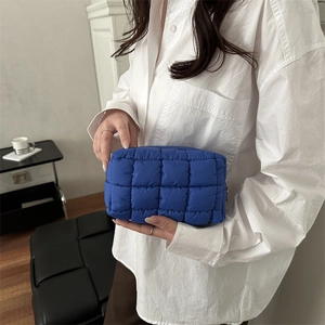 Minimalist blue quilted nylon clutch bag with puffy checkered design for women