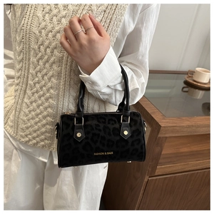 Detail of black leopard print mini Boston bag with faux fur texture and leather straps