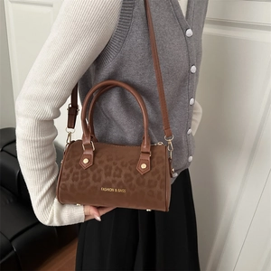 Brown leopard print boston shoulder bag with adjustable strap and golden hardware