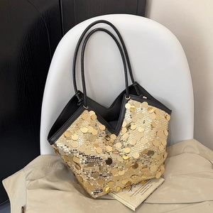 Detailed view of golden sequins on chic tote bag with V-shaped top and black handles