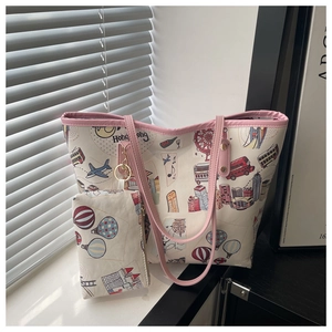 Detail of a large cream tote bag featuring a vintage travel cartoon print and matching small pouch