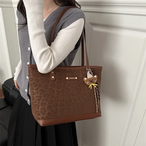 Retro leopard print tote bag with brown leather trim and a cute plush bear charm
