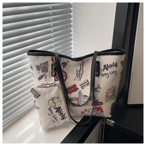 Detail view of the travel-themed tote bag set featuring cartoon illustrations and black trim