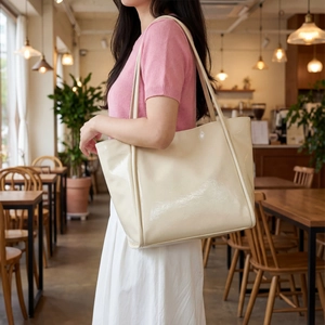 Chic beige glossy tote bag with minimalist design for daily office commute fashion