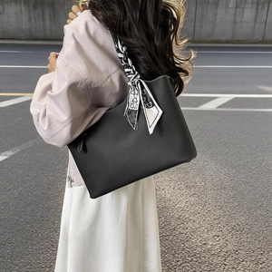 Retro black leather tote bag with geometric scarf and contrast stitching on shoulder