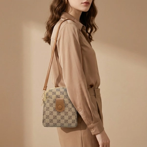 Detail of vintage jacquard crossbody bag with brown leather trim and shoulder strap