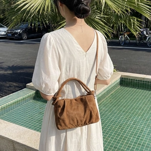 Brown suede vintage handbag with soft pleats and shoulder strap for women