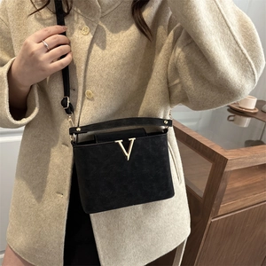 Elegant black matte leather handbag with gold V logo and crossbody strap for women