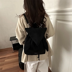 Minimalist black faux suede drawstring backpack with triangle flap and fashion text