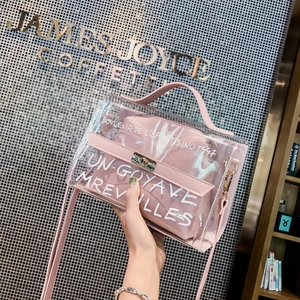 Detail of pink transparent PVC handbag with dual straps and internal pouch