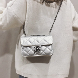 Detail of silver quilted handbag featuring metallic finish and double-C turn-lock closure
