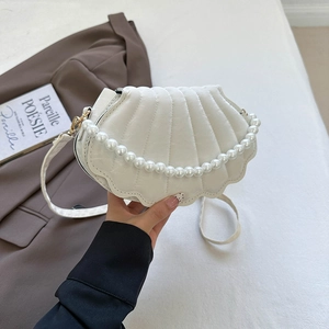 Detail of white shell handbag with pleated texture and round pearl handle for women