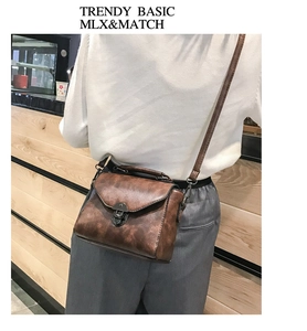 Retro brown leather crossbody bag with metal buckle shown on model in indoor setting