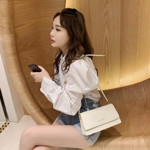 Minimalist beige baguette shoulder bag for women with gold chain and flap closure