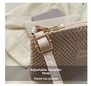 Detail view of woven beige tote bag featuring an adjustable strap with gold square buckle