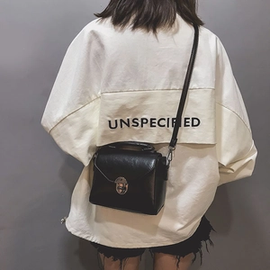 Rear view of a black minimalist PU leather crossbody bag with silver round metal lock