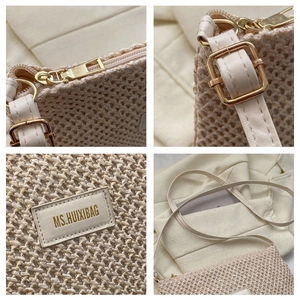 Detailed close-up of woven crossbody bag with gold hardware and leather brand patch