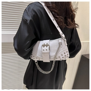 Detailansicht der weißen Tasche mit Krokodilmuster, Silbernieten und Metallkette