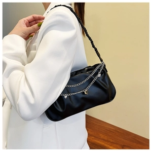 Detail of black cloud pleated shoulder bag with silver chains and heart pendant