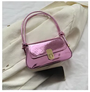 Detail of pink metallic shoulder bag with gold twist lock and knot strap detail