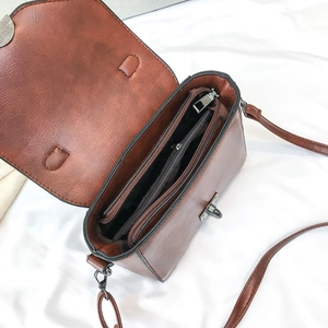 Vintage brown leather crossbody bag with dual main compartments and internal zip pocket