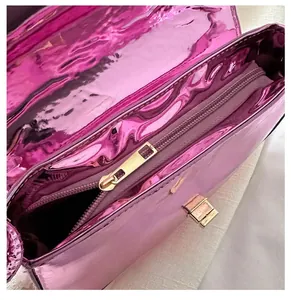 Detail of smooth gold-tone metal zipper on a purple vintage shoulder bag for women