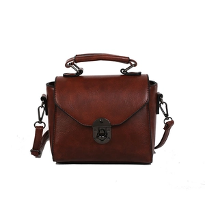 Classic retro brown faux leather handbag with top handle and crossbody strap