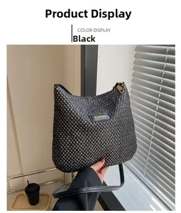 Macro shot of black woven texture and brand logo detail on minimalist tote bag