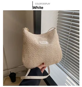 Detail of white woven crescent hobo bag with MS.HUIXIBAG leather logo patch