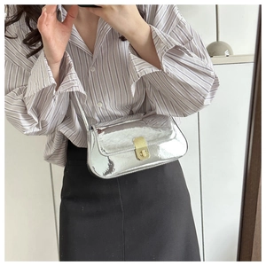 Chic silver metallic shoulder bag with gold twist lock shown in a mirror selfie