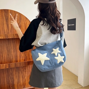 Minimalist navy blue canvas tote bag with white plush stars for women's daily commute