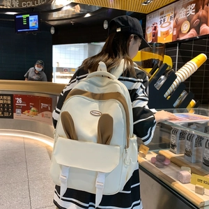 Minimalist cream and brown student backpack with cute bunny ears for casual travel use