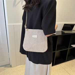 Elegant cream straw woven tote bag for women shown in a modern lifestyle setting