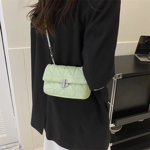 Quilted mint green crossbody bag with silver metal chain strap and twist-lock closure