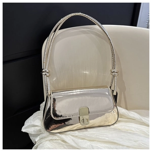 Detail of silver mirror shoulder bag with gold metal twist lock and knot strap