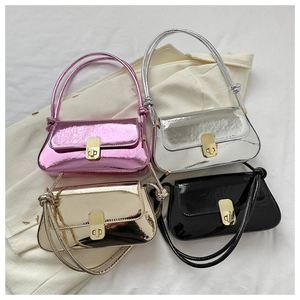 Flat lay of colorful baguette shoulder bags in metallic pink, silver, gold and black