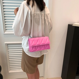 Bright pink PU leather crossbody bag with geometric quilted pattern and silver chain strap