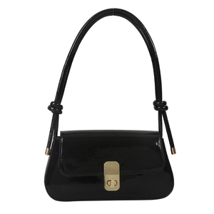 Minimalist black patent leather underarm bag with gold buckle and knotted strap accents