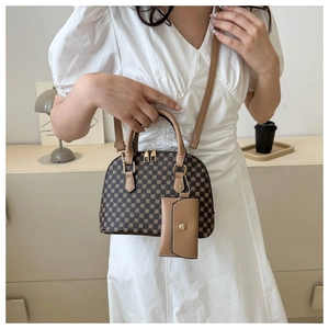 Close-up of a retro pattern crossbody bag with mini coin purse and leather strap