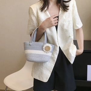 Minimalist hand-woven bucket bag with sunflower detail and elegant grey striped texture
