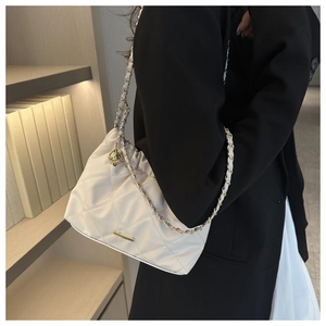 Elegant beige quilted crossbody bag with golden chain strap and metallic ball detail